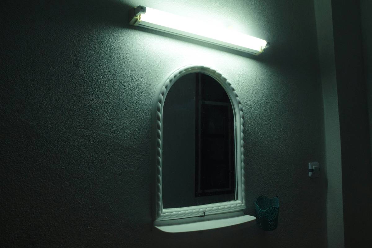 Close-up of led lighting for bathroom mirror showing aluminum-backed strip behind glass